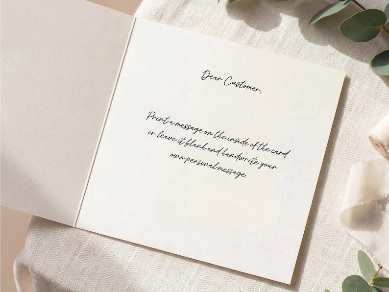 May include: A square off-white greeting card opened to reveal black printed text that reads: Dear Customer. Print a message on the inside of the card or leave it blank and handwrite your own personal message. The card has a smooth, matte finish.