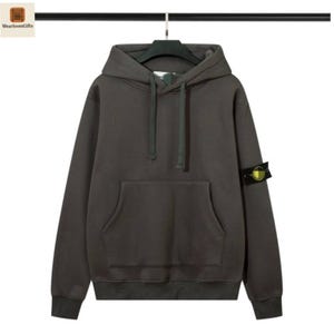 May include: A dark gray hoodie with a drawstring hood and a kangaroo pocket. The sweatshirt has a patch on the left sleeve. The hoodie is hanging on a black hanger.