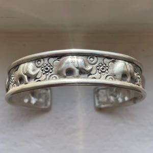 May include: A white ceramic mug with a black handle and the text "But First, Coffee" in a black, bold font. The mug is on a white surface. The mug appears to be 12 ounces.