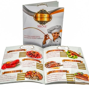 May include: A restaurant menu with the words "Heritage Grill" and "Menu" on the cover. Inside, the menu features seafood and fish dishes, including shrimp, lobster, crab, snapper, tuna, and salmon. A chef is pictured on the cover.