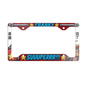 May include: A rectangular red license plate frame featuring the blue text FRANKY at the top and SUUUPERRR!!! at the bottom. The frame includes yellow star graphics, Japanese characters on the sides, and a cartoon character illustration.