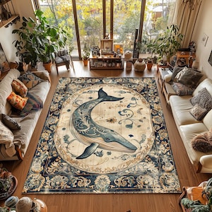 May include: A large, rectangular area rug with a detailed design. The rug features a central image of a blue whale surrounded by floral and scrollwork patterns. The border is a dark blue with ornate designs, creating a vintage aesthetic.