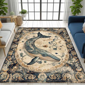 May include: A rectangular area rug featuring a detailed illustration of a whale in shades of blue and gray, set against a cream-colored background. The rug has a dark blue border with floral patterns, creating a vintage aesthetic.