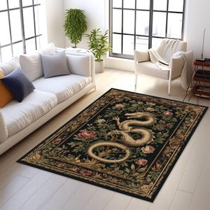 May include: A rectangular black rug with a detailed design featuring a golden dragon, surrounded by pink and green floral elements. The rug has a decorative border and is placed on a light-colored wooden floor.