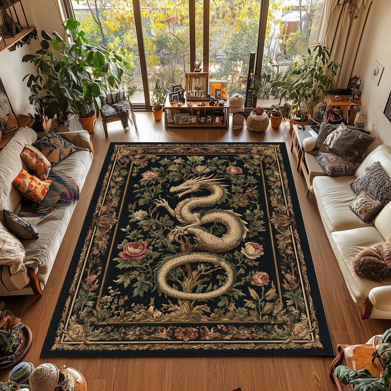 May include: A large, rectangular area rug with a black background and a detailed design. The rug features a cream-colored dragon, pink roses, and green foliage. The border is a dark gold color.