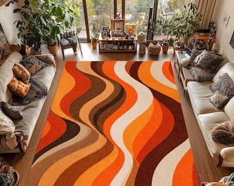 Puede incluir: Una alfombra rectangular grande con un diseño retro. La alfombra presenta un patrón ondulado en tonos naranja, marrón y crema. La alfombra está colocada sobre un suelo de madera en un salón, con sofás y plantas visibles.