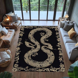 May include: A black area rug with a large, stylised snake design in beige and gold tones. The snake is centrally placed, its body forming a symmetrical pattern. The rug has a floral border.