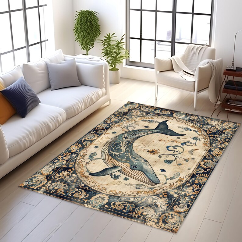 May include: A rectangular area rug featuring a whale design. The whale is depicted in shades of blue with intricate details, set against a light beige background. The rug has a dark blue and beige floral border, suitable for living room decor.