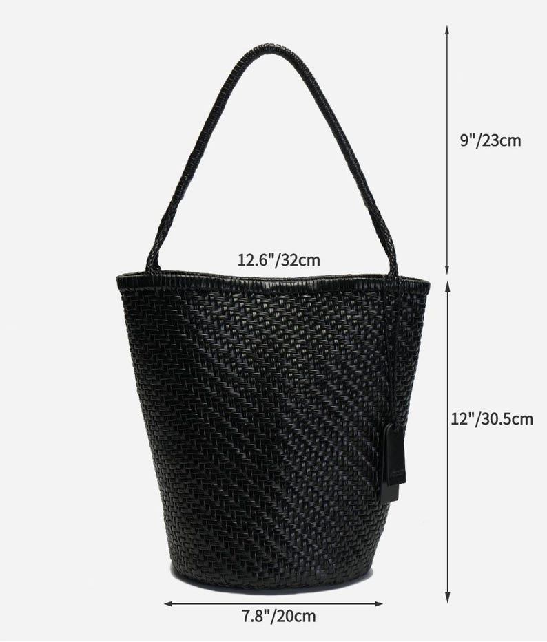 May include: Black woven tote bag with a handle. The bag is 12 inches (30.5 cm) tall, 12.6 inches (32 cm) wide, and 7.8 inches (20 cm) deep. The handle is 9 inches (23 cm) long. The bag has a tag attached.