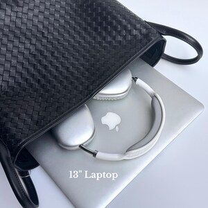 May include: A black woven leather tote bag with a silver 13-inch laptop and white and silver headphones inside. The laptop has the Apple logo on the lid.