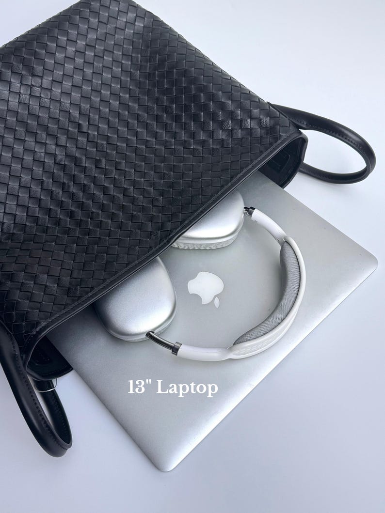 May include: A black woven leather tote bag with a silver 13-inch laptop and white and silver headphones inside. The laptop has the Apple logo on the lid.