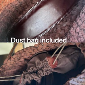May include: Close-up of a brown woven leather tote bag. The interior features a dark brown lining and a drawstring closure. The text "Dust bag included" is visible.