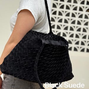 May include: Black suede tote bag with a woven design. The bag has braided handles and the words "Black Suede" are printed on the bottom of the image.