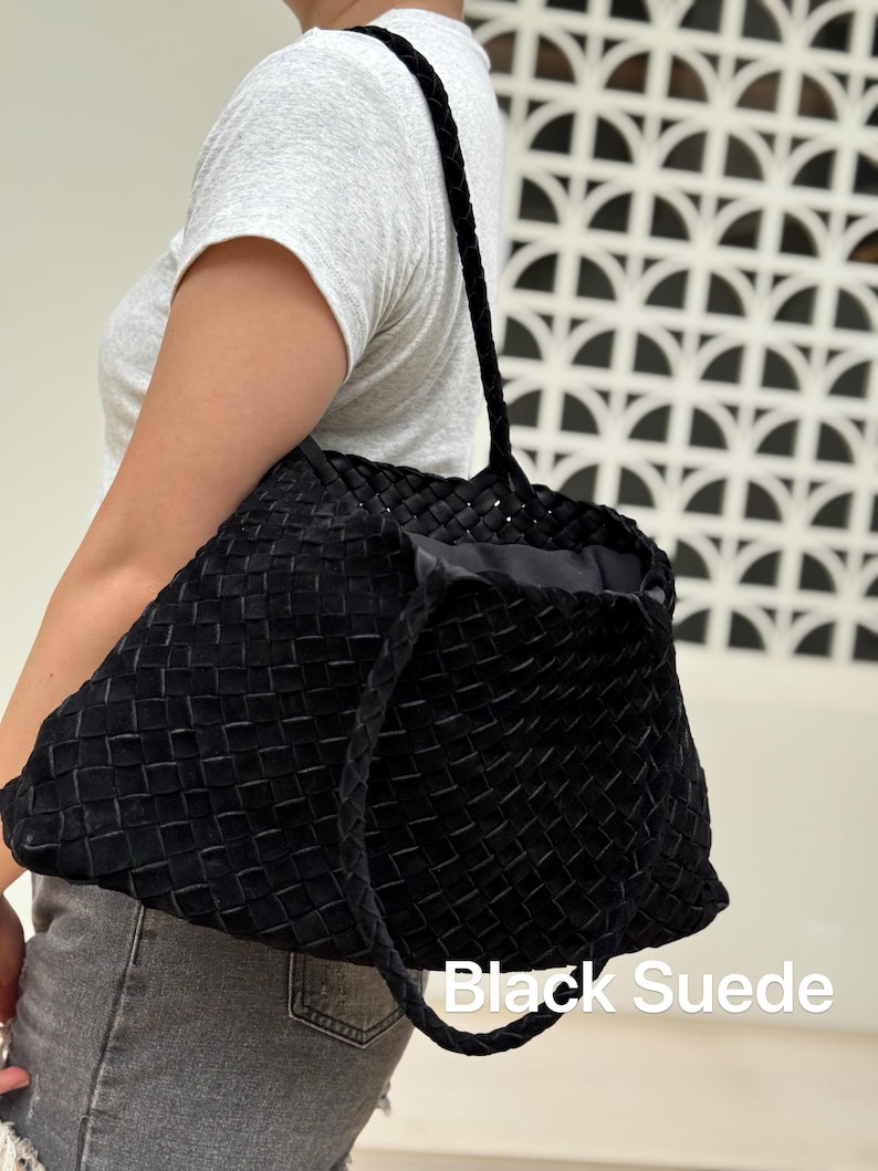 May include: Black suede tote bag with a woven design. The bag has braided handles and the words "Black Suede" are printed on the bottom of the image.