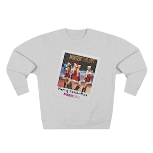 May include: A light gray sweatshirt featuring a printed image of a photo with the text "WINTER TALENT" at the top and "Merry Fetch-Mas" and "MEANGIRLS" at the bottom. The photo shows four people in red outfits.