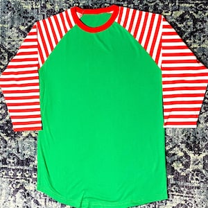 Bright Green Raglan Shirt with Curved Hem and Candy Cane Striped Arms in Red and White.