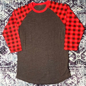 Red Buffalo Plaid Arm Raglan with Dark Heather Gray Body in Women's Sizes. Shirt has a Rounded Hem that is longer than a standard shirt.