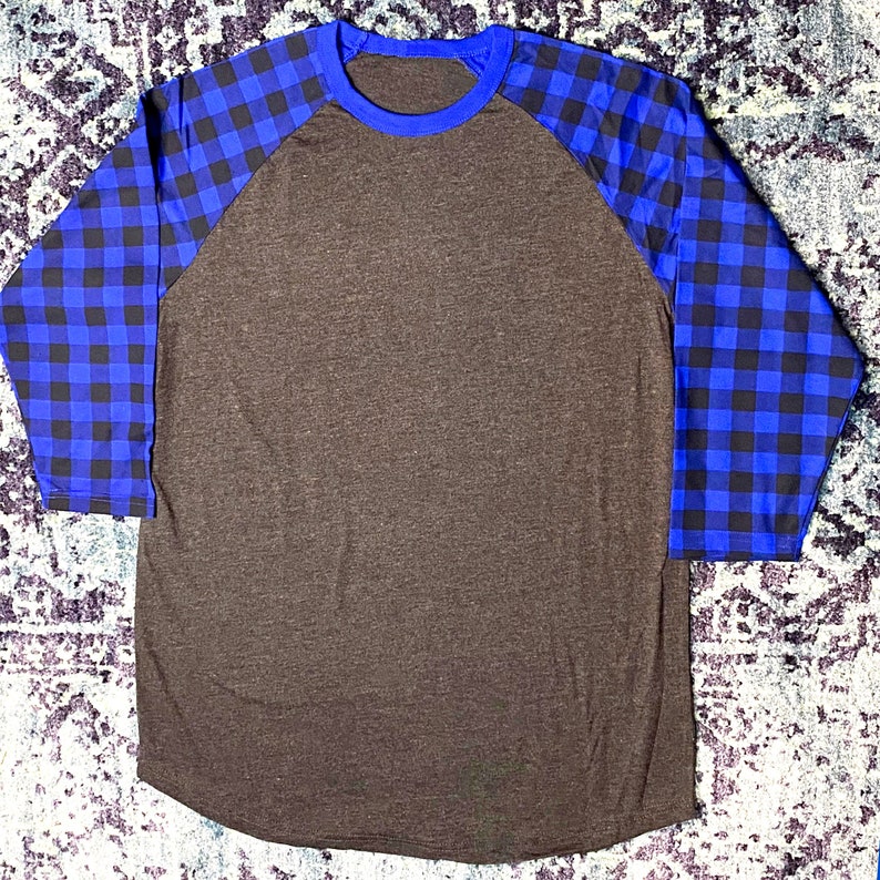 Royal Blue Buffalo Plaid Sleeve 3/4 Raglan Shirt with Dark Heather Grey/Gray Body. Shirt has a longer length and rounded hem