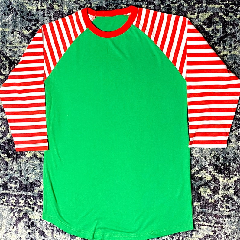 Bright Green Raglan Shirt with Curved Hem and Candy Cane Striped Arms in Red and White.