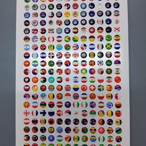 May include: A white rectangular sheet featuring a grid of numerous small, circular, glossy stickers. Each sticker displays a different national flag in vibrant colours. The stickers are arranged in uniform rows and columns across the entire surface.