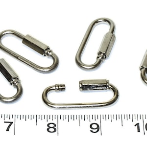 May include: Five silver metal quick links, each with a threaded barrel in the center. The links are approximately 1 inch long and are shown next to a ruler.