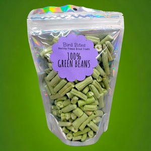 May include: A clear plastic bag filled with green bean bird treats. The bag has a purple label that says "Bird Bites Healthy Freeze Dried Treats 100% Green Beans".