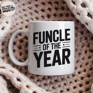 May include: White ceramic mug with the text "FUNCLE OF THE YEAR" in bold black letters. The mug has a curved handle and is set against a textured, off-white background. A small logo that says "NOT YOUR REGULAR MUG" is in the top left corner.