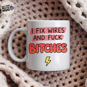May include: A white ceramic mug featuring the black text I FIX WIRES AND FUCK BITCHES with a yellow lightning bolt icon below. The text is highlighted by pink brush strokes. A small circular logo in the top left corner reads NOT YOUR REGULAR MUG.