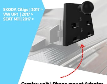 May include: A black CarPlay unit and phone mount adapter. The adapter has a rectangular shape with multiple openings and a round knob. Text on the image includes "SKODA Citigo | 2017 >", "VW UP! | 2017 >", and "SEAT Mii | 2017 >".