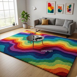 May include: A rectangular area rug featuring a vibrant, multi-coloured wavy pattern in shades of red, orange, yellow, green, blue, and purple. The rug has a textured, tufted surface and includes the white text Living rugss printed on the surface.