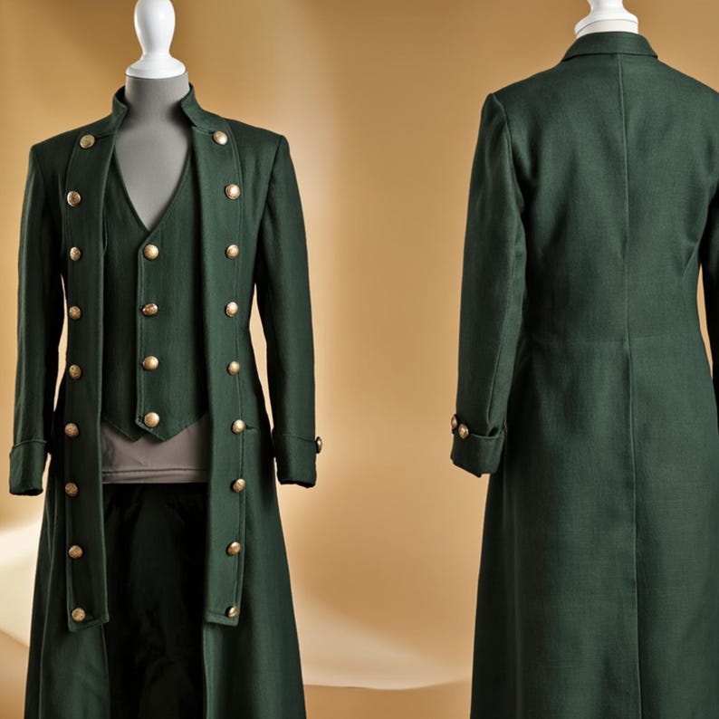 May include: A dark green, three-piece suit displayed on a mannequin. The suit includes a long coat with gold buttons, a vest, and matching pants. The coat has a high collar and long sleeves. The vest has gold buttons. The suit is made of a textured fabric.