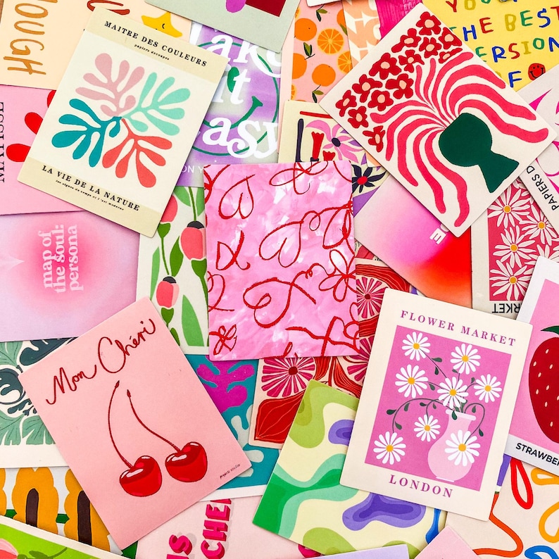 May include: A collection of colorful art prints with various designs. Some prints feature floral arrangements, abstract shapes, and text like "Flower Market London" and "Mon Ch&eacute;ri". The color palette includes pinks, greens, reds, and oranges.