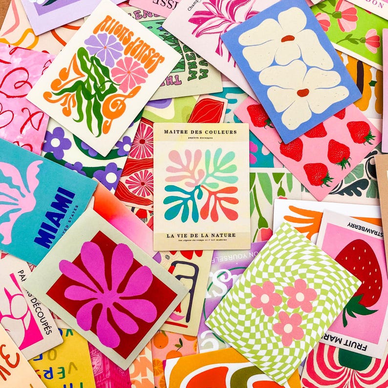 May include: A collection of colorful art prints with various designs. Some prints feature floral patterns, strawberries, and the text "Miami" and "Rions danser". The prints are in shades of pink, blue, green, and orange.