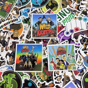 May include: A collection of colorful stickers featuring the animated series "Wild Kratts." The stickers showcase various characters and scenes from the show, with vibrant illustrations and the show's logo prominently displayed.