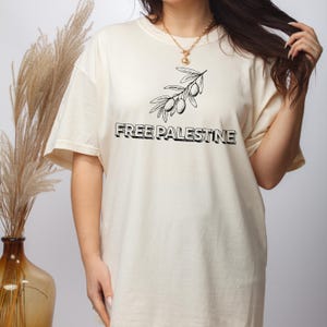 Free Palestine Tee – Oversized Black Shirt with Olive Branch Graphic & Bold Message for Peaceful Advocacy   Protest Style