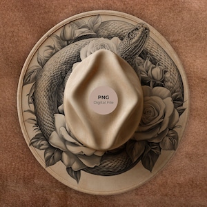 May include: A tan fedora hat featuring a detailed illustration of a snake and roses. The hat has a light brown crown and brim. The image includes a circular sticker that says "PNG Digital File".