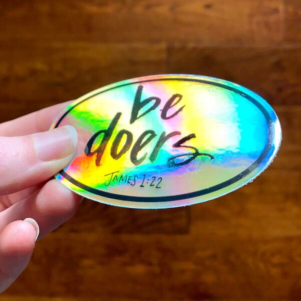 Be Doers holographic sticker featuring my watercolor lettering from James 1:22, But be doers of the word, and not hearers only, metallic