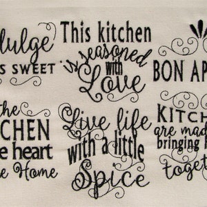 May include: Black and white embroidered kitchen towel with the text "Indulge Life is Sweet", "This kitchen is seasoned with Love", "Bon Appetit", "The Kitchen is the heart of the Home", "Live life with a little Spice", and "Kitchens are made for bringing families together".
