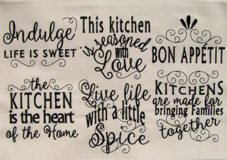 May include: Black and white embroidered kitchen towel with the text "Indulge Life is Sweet", "This kitchen is seasoned with Love", "Bon Appetit", "The Kitchen is the heart of the Home", "Live life with a little Spice", and "Kitchens are made for bringing families together".