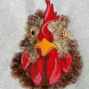 May include: Embroidered rooster head with a red comb, yellow beak, and brown feathers.