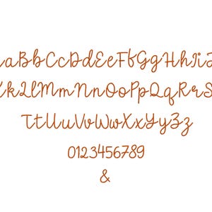 May include: A complete alphabet and numbers 0-9, plus the ampersand symbol, are displayed in a handwritten, cursive font. The letters and numbers are in a warm brown color against a white background.