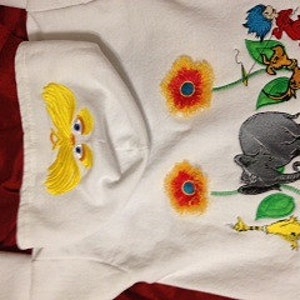May include: White hooded sweatshirt with an embroidered design featuring the character of the Lorax, flowers, and characters from the book "The Lorax" by Dr. Seuss.
