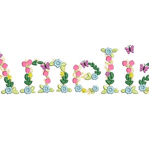May include: The name "Amelia" is spelled out in pink, blue and green flowers with butterflies. The letters are surrounded by leaves and vines.
