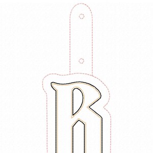 May include: A white letter B with a gold outline. The letter is surrounded by a pink dashed line.