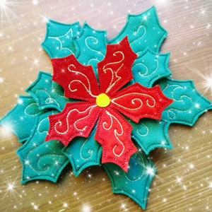 May include: A red poinsettia flower with gold embroidery is surrounded by teal holly leaves with gold embroidery. The flower and leaves are made of felt.
