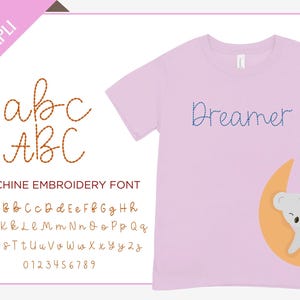 May include: A machine embroidery font with a cursive alphabet and numbers. The font is shown on a pink t-shirt with the word "Dreamer" embroidered in blue thread. A cartoon koala is sleeping on a crescent moon.