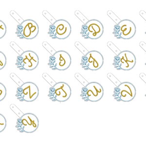 May include: Set of 26 alphabet letter embroidery designs featuring a gold letter with a blue floral design in a circle. Each letter is on a separate white background.