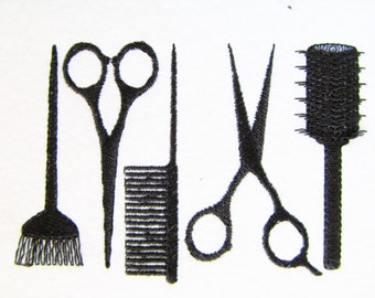 May include: A set of black hairdressing tools including a pair of scissors, two combs, and a round brush.