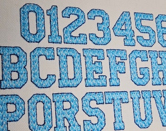 May include: Embroidered alphabet letters in a blue and white pattern. The letters are uppercase and are arranged in three rows. The letters are 0123456, BCDEFGH, and PORSTUV.