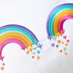 May include: Two embroidered rainbows with stars and hearts falling from them. The rainbows are purple, blue, green, yellow, pink, and orange. The stars are yellow, green, and blue. The hearts are purple, pink, and orange.